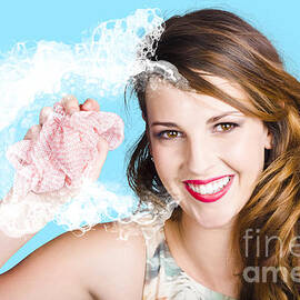 Cleaner woman with dish cloth by Jorgo Photography