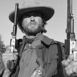 Clint Eastwood holding pistols posing from The Outlaw Josey Wales 1976 by Silver Screen