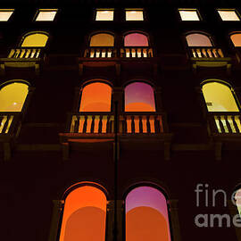 Coloured lights in the windows of the Benetton building in Venice, Italy by Neale And Judith Clark