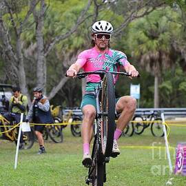 Cyclist Performing Wheelie at Outdoor Event 2500 by Donn Ingemie