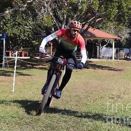 Cyclist Racing Through Park 2646 by Donn Ingemie