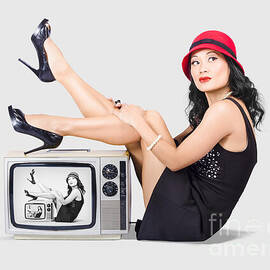 Lovely asian pinup girl posing on vintage tv set by Jorgo Photography