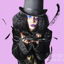 Magician blowing feathers by Jorgo Photography