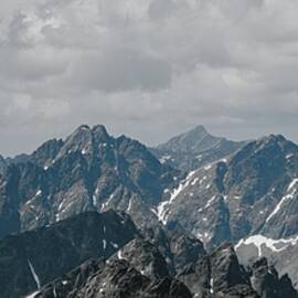 Majestic Mountain Range Under Overcast Sky by Robert Grac