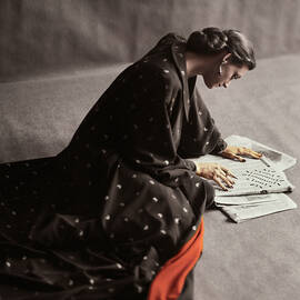 Model Doing A Newspaper Crossword Puzzle by Richard Rutledge