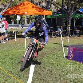 Mountain Biker Racing Through Outdoor Course 2668 by Donn Ingemie