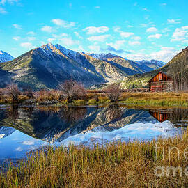 Mountain Reflection Near a Rustic Cabin by Shirley Dutchkowski