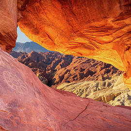 Natural arch on Atlatl Rock with scenic backgound added by Steven Heap
