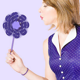 Pretty pin up girl playing with purple pinwheel by Jorgo Photography