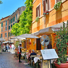 restaurant on a cobblestone street, in Roma by Stefano Senise