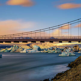 Road bridge over Jokulsarlon glacier lagoon in Iceland at sunset by Miroslav Liska