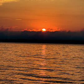 Serene Sunrise Over Calm Waters by William Norton