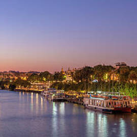 Seville Torre del Oro riverside at night by Neale And Judith Clark