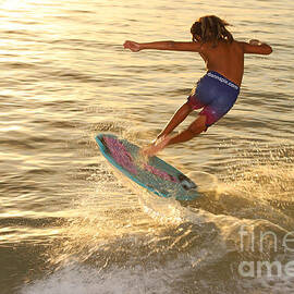 Skimboard Trick at Sunset by Donn Ingemie