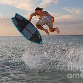 Skimboarder Mid-Air at Sunset by Donn Ingemie