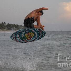Skimboarder Soars Above Ocean Waves 3431 by Donn Ingemie