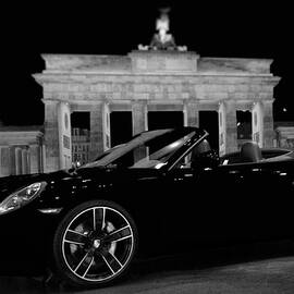 Sleek Convertible Black Porsche Near Brandenburg Gate by Stefano Senise