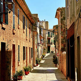 Sunlit Stone Alley in Alcudia Old Town, Majorca by Travel Essayist