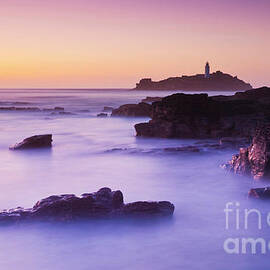 Sunset at Godrevy lighthouse, Cornwall, England by Neale And Judith Clark