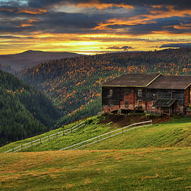 Sunset over a farmhouse barn in autumn near Rondane National Park, Norway by Miroslav Liska