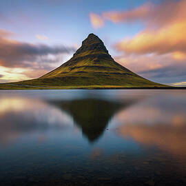 Sunset over Kirkjufell mountain with reflection in a nearby lake in Iceland by Miroslav Liska