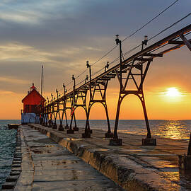 Sunset Over Pier and Lighthouse by Michael Collins