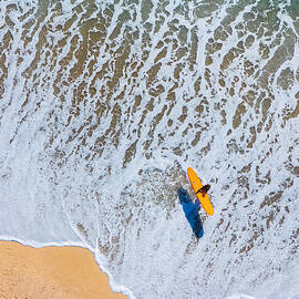 Surfer on a Sandy Beach by Oceanic SkyView