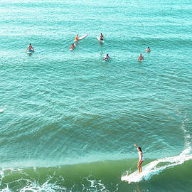 Surfers Riding the Ocean Waves by Oceanic SkyView