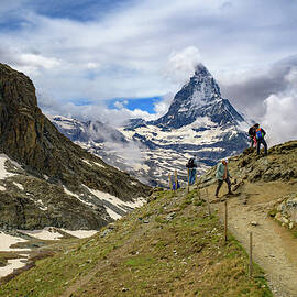 Tourists Hiking Near Snow-Covered Matterhorn in Swiss Alps by Miroslav Liska