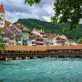 Traditional covered wooden bridge spanning the Aare River in Thun, Switzerland by Miroslav Liska