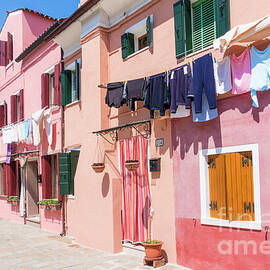 Washing drying outside coloured houses on the island of Burano in the Venice lagoon, Venice, Italy by Neale And Judith Clark