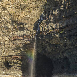 Waterfall at Honololo Sea Cave on the NaPali Coast of Hawaii by Nancy Gleason