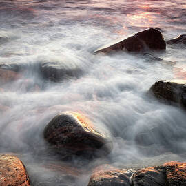 Wet Rocks In The Surf At Sunrise.  by Jeff Sinon