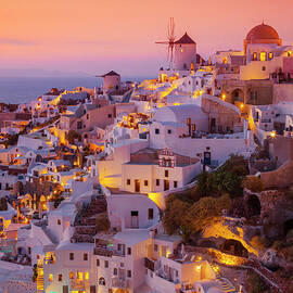 Windmill and white houses at sunset, Oia, Santorini, Greece by Neale And Judith Clark