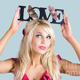 Woman holding love sign by Jorgo Photography
