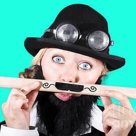 Woman With Fake Beard Holding A Pencil Having Mustache by Jorgo Photography