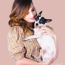 Young woman holding dog by Jorgo Photography