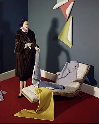 Wall Art featuring the photograph A Woman With Assorted Pieces Of Fabric #1 by Herbert Matter