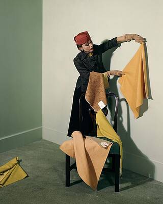 Wall Art featuring the photograph A Woman With Assorted Pieces Of Fabric #2 by Herbert Matter