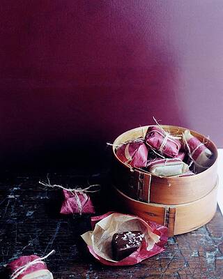 Baking Wall Art featuring the photograph A Bamboo Steamer With Paper Packages by Romulo Yanes
