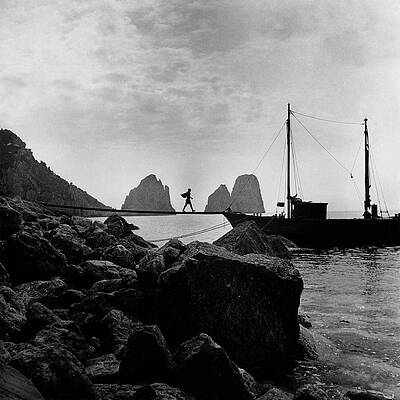Silhouette of Man Walking on Pier Photograph