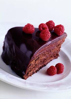 Baking Wall Art featuring the photograph A Chocolate Pecan Cake With Raspberries On Top by Romulo Yanes