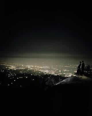 Couple Overlooking City Lights at Night Photograph