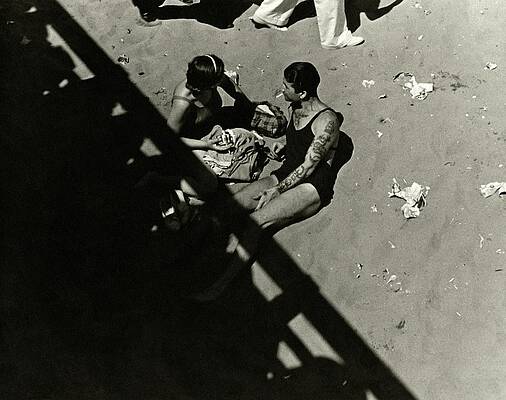 Couple Relaxing on a Sandy Beach Photograph