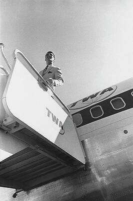 Man Standing on TWA Airplane Stairs Photograph