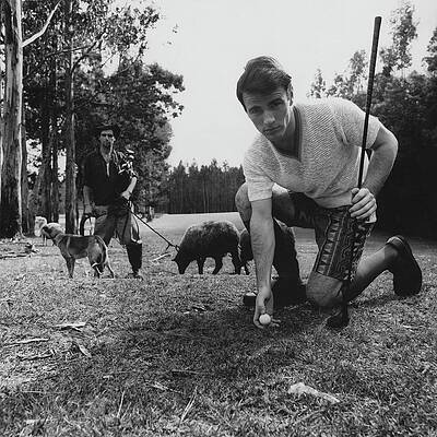 Man with Golf Club and Animals Photograph