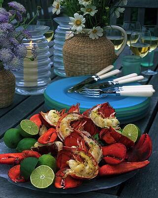 Candle Wall Art featuring the photograph A Meal With Lobster And Limes by Romulo Yanes