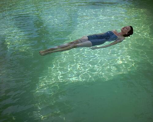 Woman Relaxing in Pool Wall Art