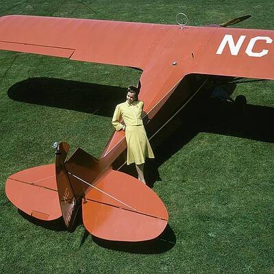 Woman Leaning on Vintage Airplane Photograph