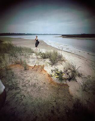 Woman Walking on Coastal Sand Photograph